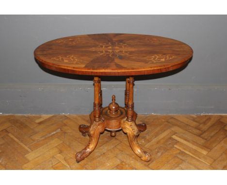 A late Victorian walnut, floral marquetery inlaid and strung loo table of small size, the oval top raised on four columns, le