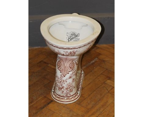 An early 20th century lavatory basin, ' The Sanitas Wash Down Closet' florally transfer decorated. Bowl diameter 35cm