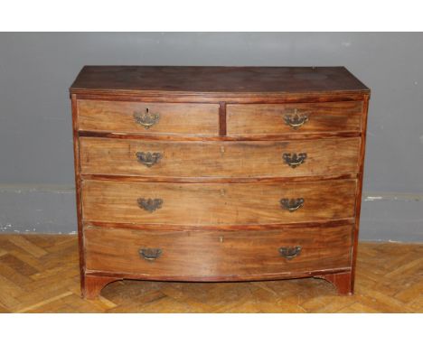 A George III mahogany bow front chest of two short and three long drawers with brass drop handles, raised on bracket feet. 90