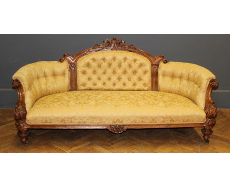 A Victorian walnut framed, button upholstered drawing room three person settee, raised on leaf carved, turned supports, 95 x 