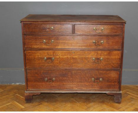 A George III oak chest of two short and three long drawers with swan neck drop handles, raised on bracket feet, 107 x 123 x 5