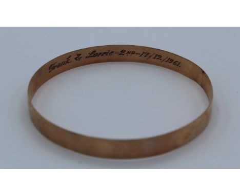 A 9ct stamped bangle in yellow metal ( tests as 9ct gold) engraved inside. Approximate weight 23.1gm