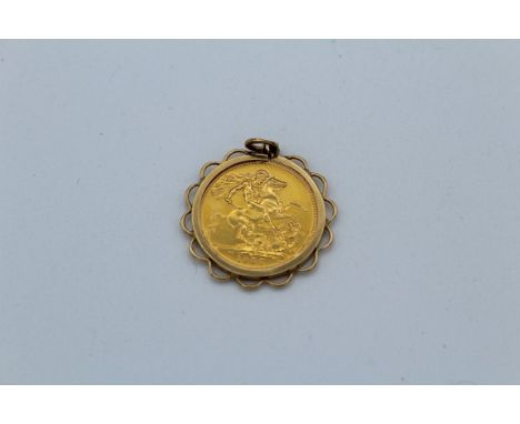An Elizabeth II sovereign in a 9ct gold mount. 1957 young head Gillick portrait