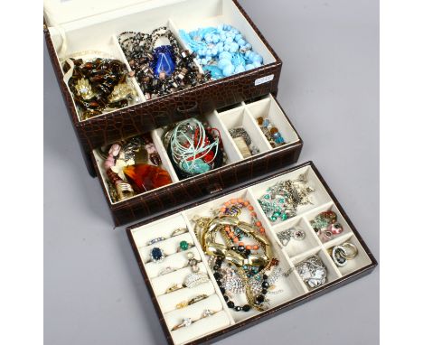 A jewellery case containing assorted costume jewellery including dress rings, charms etc.