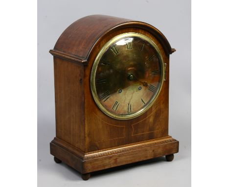 A mahogany cased eight day dome top mantle clock with brass face, quarter chiming on Westminster raised on bun feet complete 