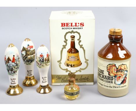 A boxed and sealed Wade decanter of Bell's Scotch Whisky along with a small collection of alcohol and containers.
