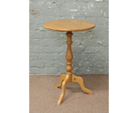 An Ercol Golden Dawn tripod wine table.