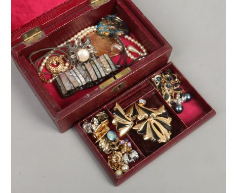 A red leatherette fitted jewellery box and assorted dress jewellery including Monet faux grey pearls earrings, 1950s brooch a