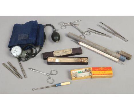 A quantity of medical apparatus including a blood pressure testing device, early 20th century glass syringe in box etc, along