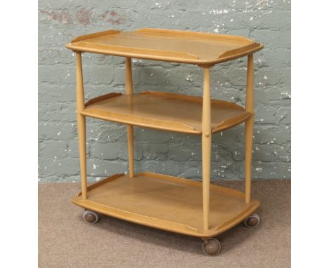 An Ercol Golden Dawn three tier tea trolley.