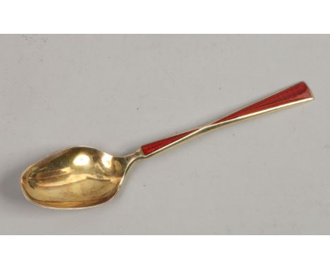 A Norwegian silver gilt spoon with red engine turned enamel decoration. 