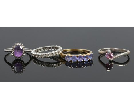 Four silver dress rings including a gilt example, all stone set.