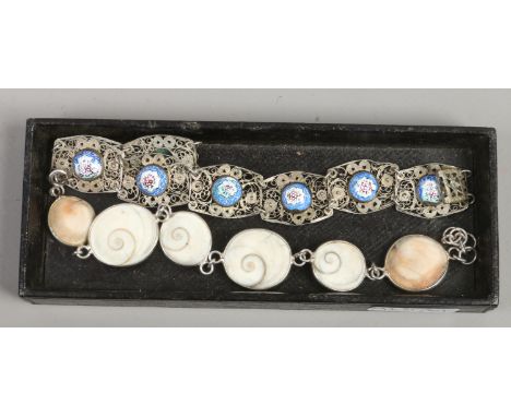 A silver filigree panel bracelet with enamel jewels and a silver mounted stone bracelet.