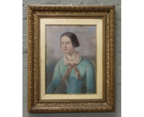 A gilt framed early 20th century pastel portrait of a woman.