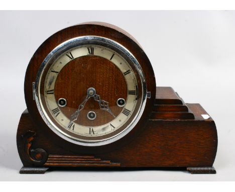An oak cased asymmetrical mantel clock Westminster chiming.