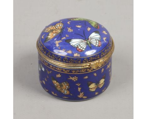 A blue enamel trinket box with gilt metal mount decorated with butterflies. 