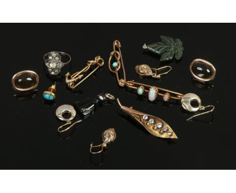 A box of yellow metal jewellery oddments including an opal bar brooch, seed pearl fouled anchor brooch, nephrite leaf pendant