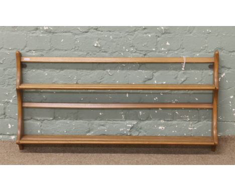 An Ercol Golden Dawn wall rack.