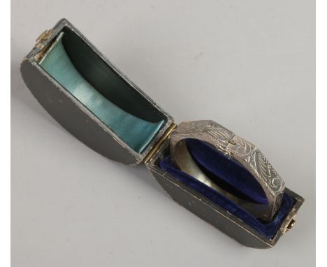 A cased engraved octagonal silver bangle stamped 925, 16.9 grams.