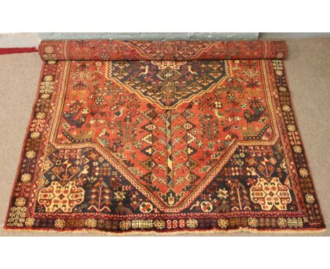 A red ground Persian Quaskhai tribal carpet with traditional design made in Iran.