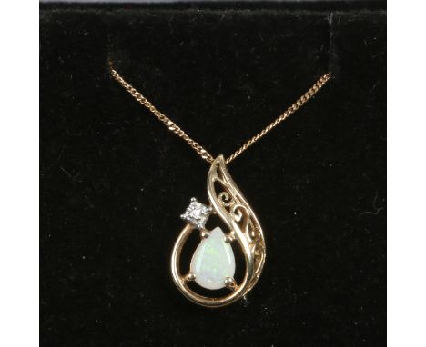 A 9ct gold opal and diamond scroll form pendant on 9ct gold trace chain.