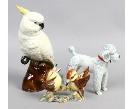 A Goebel ceramic figure of a poodle along with a Goldscheider figure of birds and a cockatoo (repaired).