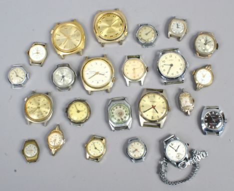 A tin of ladies and gents manual watch heads.