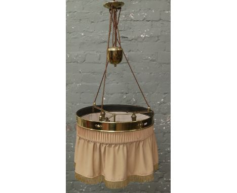 A c. 1920s brass rise and fall centre light with three branches and material valance shade.
