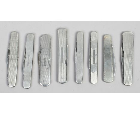 Eight folding pocket knives some with engine turned engraving.