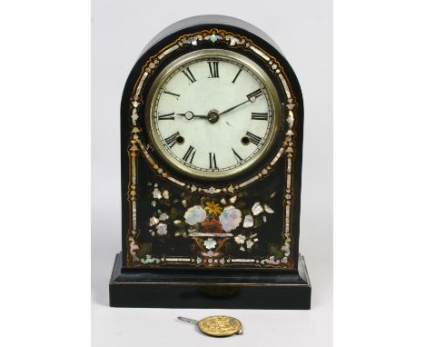 A Victorian ebonized dome top mantel clock with mother of pearl inlay, housing a twin train movement with pendulum.