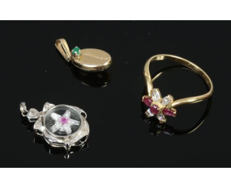 An 18ct white gold pendant with spinning diamond set centre and 18ct gold gem set coffee bean charm and an 18ct gold ruby and
