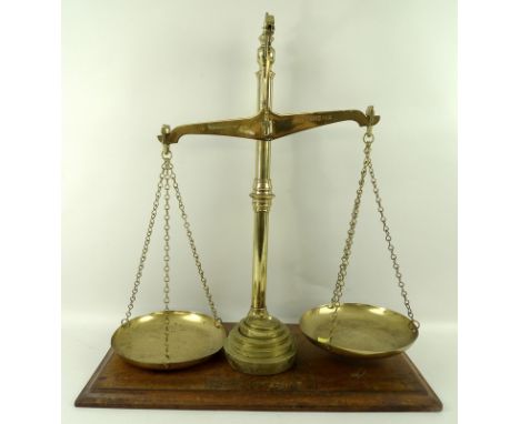 A set of vintage W & T Avery Ltd brass balance scales, with five brass weights and mahogany base, 52 by 26 by 57cm. 
