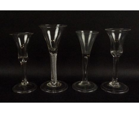 A group of four 18th century wine glasses, with folded feet air twist and tear drop stems, two bell and two trumpet shaped bo