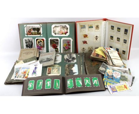 A large collection of Pre First World War postcards, in four albums and printed ephemera, the post cards include humorous and
