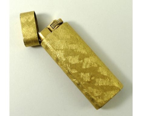 A Cartier gold plated cigarette lighter.