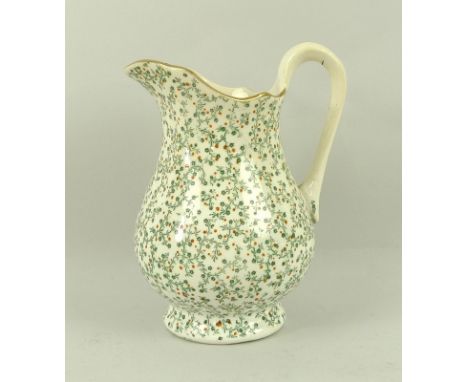A tea set, early 19th century, in cream ground decorated with green and red foliate detail, comprising milk jug, sugar/slop b