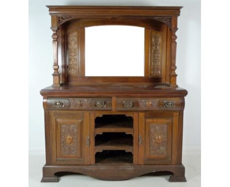 A Victorian walnut sideboard, with a mirror back upper section, flanking carved foliate panels, two carved and turned columns