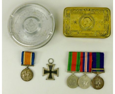 A group of WWI, Great War, and WWII medals, a Princess Mary 1914 Christmas tin, a German WWII medal, a WWII ashtray made from