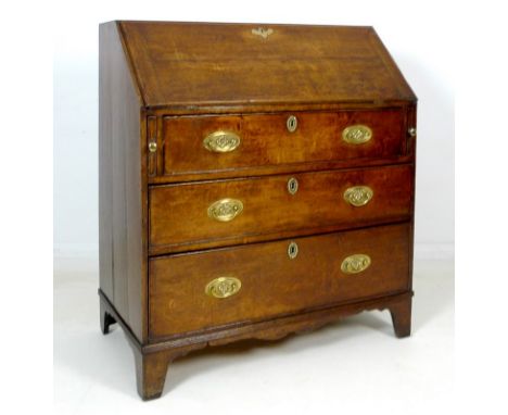 A George III oak bureau, fall front with fitted interior, three graduating drawers with cock beading and brass plate handles 