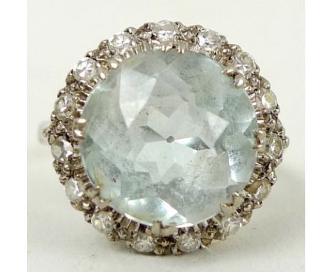 An 18ct white gold, aquamarine and diamond ring, the brilliant cut aquamarine, approx 5ct, 11mm, encircled by fifteen diamond