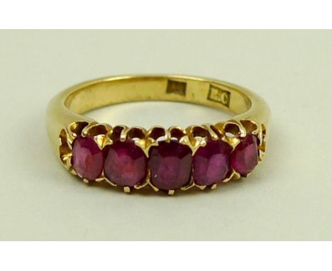 A Burmese ruby five stone and 18ct gold ring, the graduated stones, set in line, of varying colour, total approx 1ct, size L,