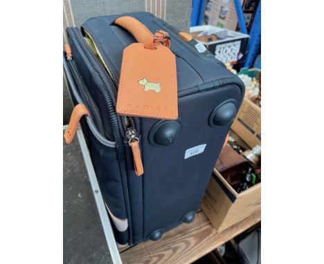 A vintage "denim" suitcase and a Radley carry case. 