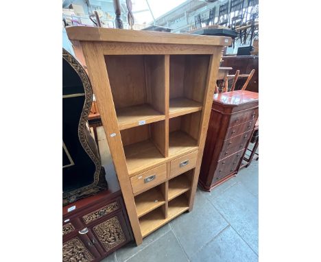 A modern light oak bookcase. 