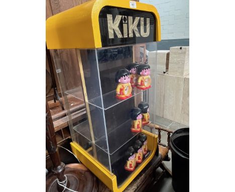 A Faberge Kiku shop display cabinet of oblong form with curved yellow top and base & perspex sides, housing 8 Kiku clocks eac