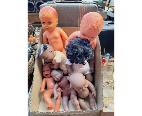 A box of vintage dolls including black dolls etc. 