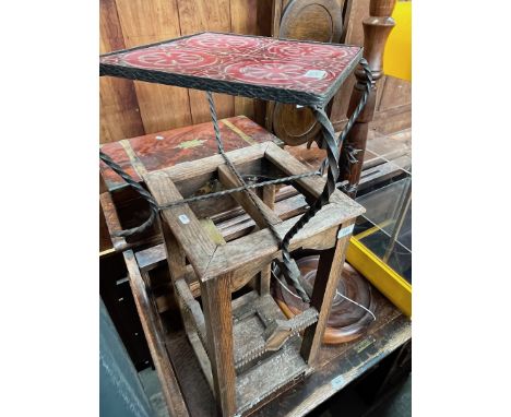 A 1920s oak stick stand together with a metal and tile top table and a carved standard lamp.