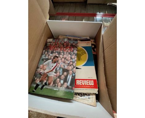 A box of sporting memorabilia including signed books by Rob Andrew and Peter Alliss. 