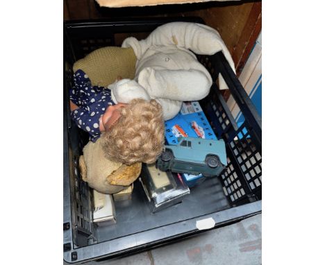 A crate containing boxed model vehicles and vintage dolls 