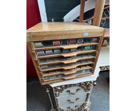 A vintage Dewhurst's Sylko set of drawers with contents. 
