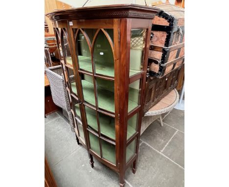 An Edwardian mahogany bow front display cabinet. 